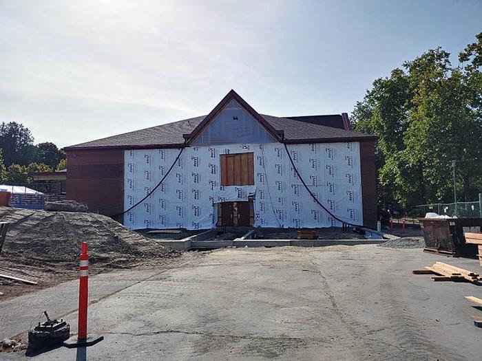 a building with a wall removed and Tyvek sheathing installed