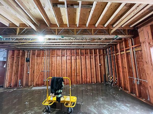 a partially finished interior with wiring runs up the wall studs and across the ceiling joists