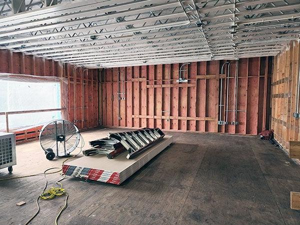 interior of a room under construction with studs and electrical lines